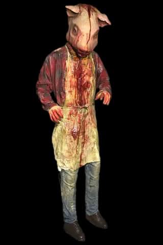Pig Head Butcher professional full-body prop in a haunted butcher shop