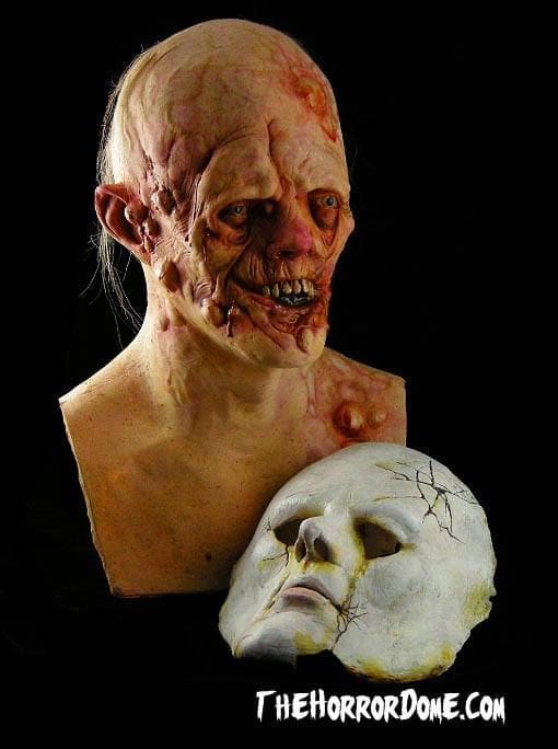 Doll Face Halloween Mask from HD Studios Pro. Two-in-one deformed face and porcelain doll disguise for double the terror. Hand-painted grotesque details like wounds, wiry hair, blisters. Incredibly detailed collector's mask perfect for embodying vengeful characters and haunting horrific events