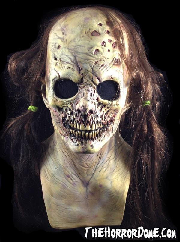 Rotting Rebecca Halloween Mask from HD Studios Pro. Hyper-realistic zombie girl disguise with decaying flesh, exposed bone, black mesh eyes. Durable movie-quality construction. Perfect for embodying undead vengeance and completing zombie costumes at haunted Halloween events.